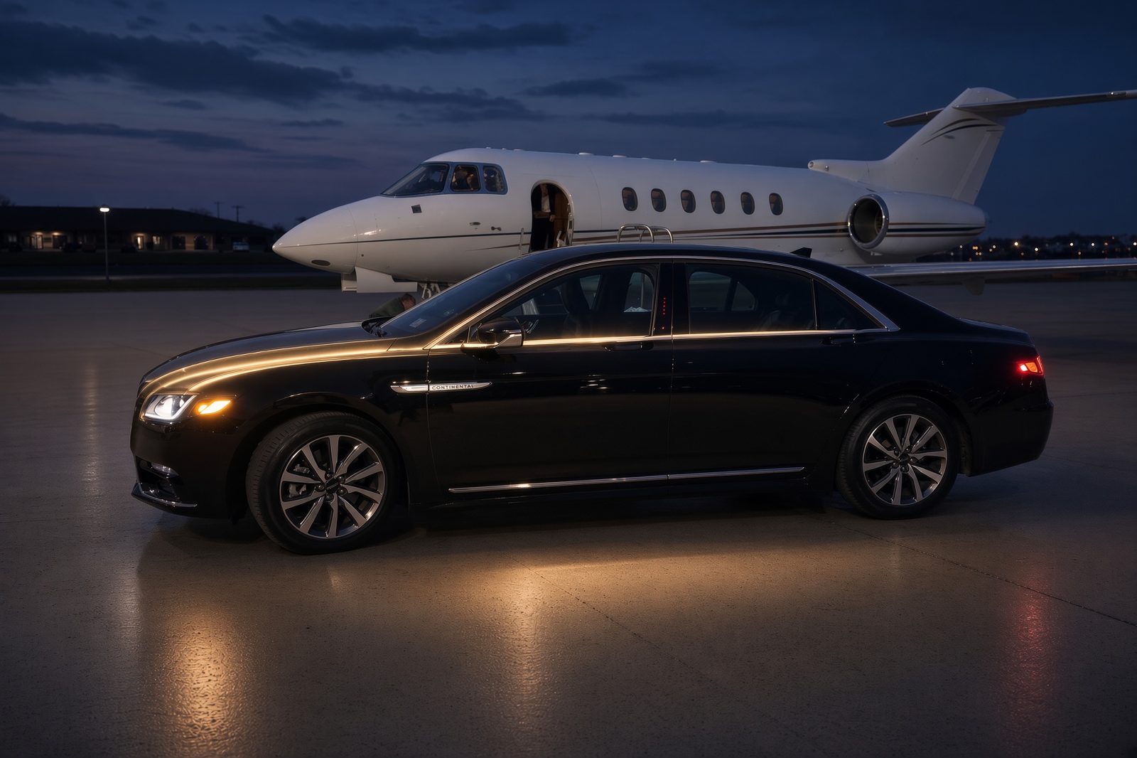 Black Lincoln Continental waiting beside a business jet on the ramp at dusk